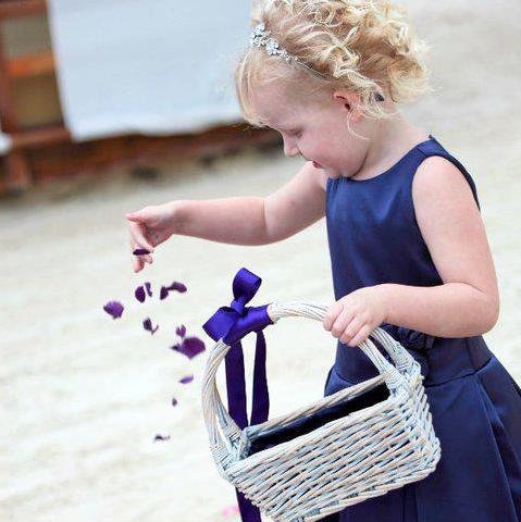 Flower girl scattering confetti petals – Purple Coloured Rose Petals from a Small White Basket