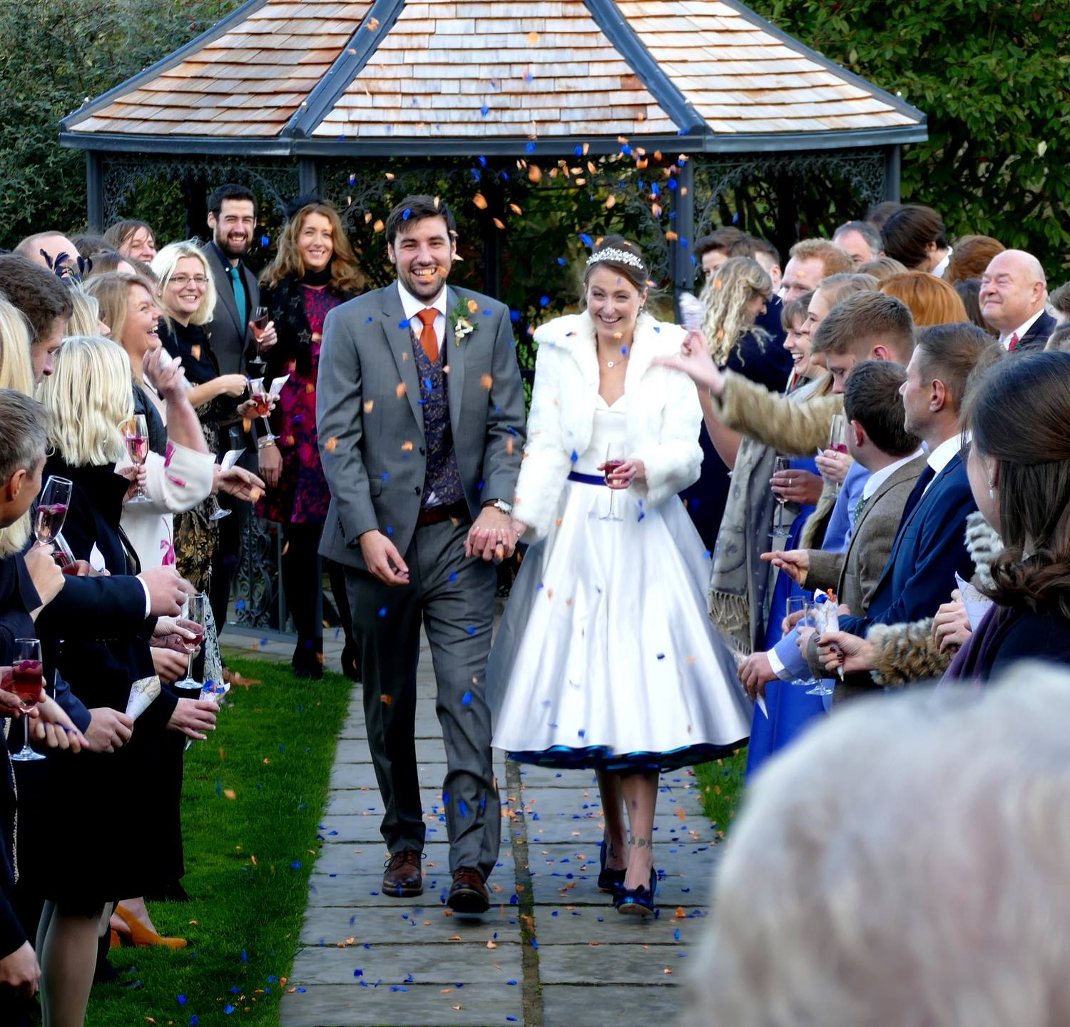 Halloween wedding confetti moment photgraph - a shower of purple and orange rose petals