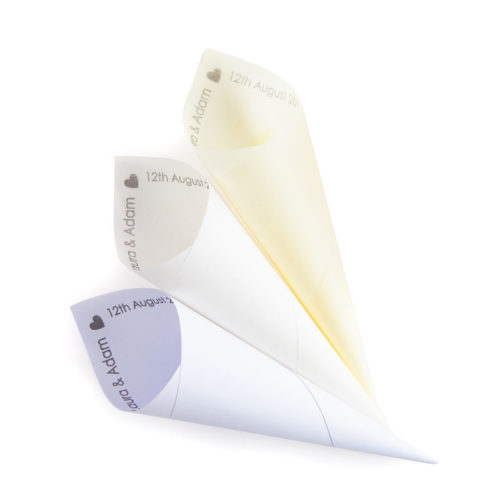 Three personalised wedding confetti cones - one translucent ivory paper, one translucent white paper and one solid white paper. All are printed with the happy couple's names and wedding date.