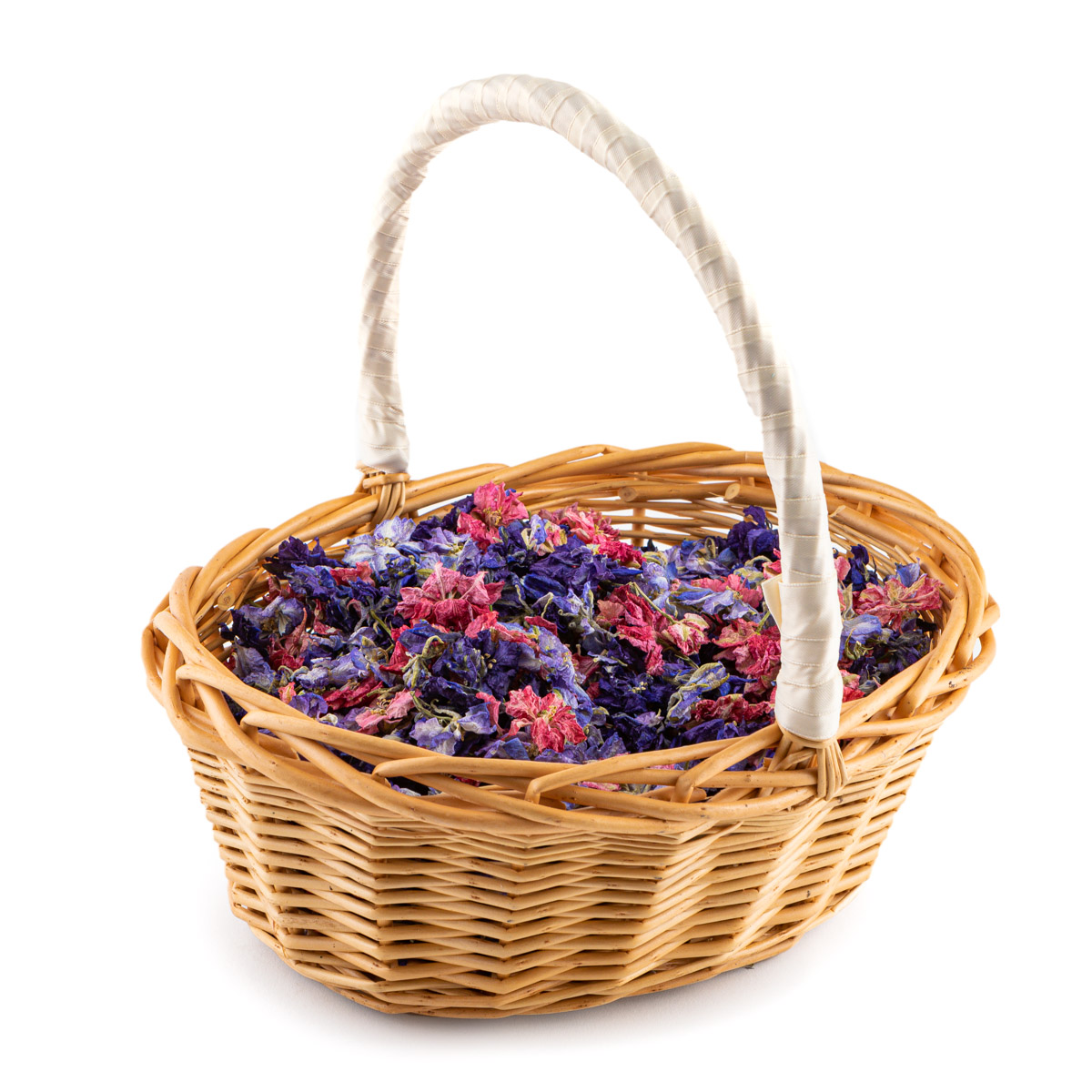 Starburst confetti petals in an oval flower girl basket with a cream ribbon covered handle