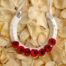 A lucky wedding horseshoe for the bride decorated with red paper poppies.