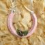 A lucky wedding horseshoe for the bride decorated with lilac rose buds, green leaves and pale pink ribbon.